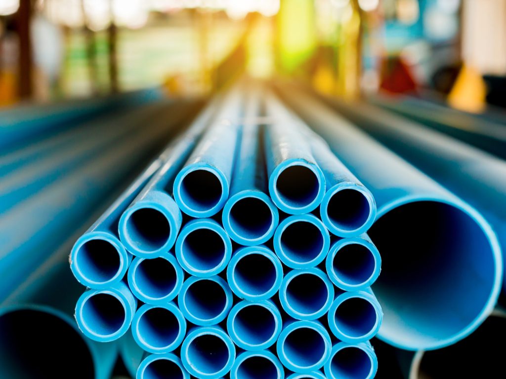 Close,Up,To,Blue,Plastic,Pipe,Background,,Pvc,Pipes,Stacked